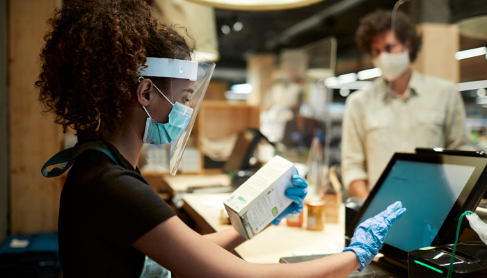 young pharmacist with PPE reflecting the employment statistics in canada