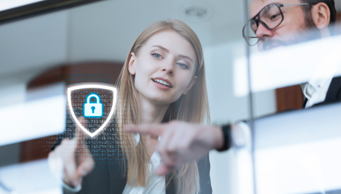 image of young woman and man in glasses pointing at a digital lock with binary numbers behind it showcasing being compliant when conducting background checks