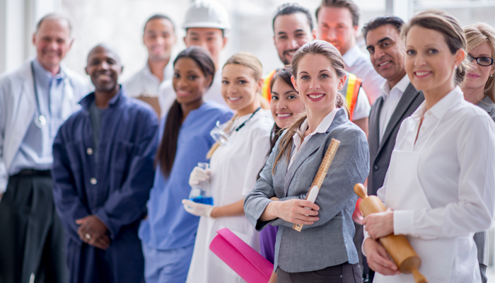 group of different professionals from different industries smiling showcasing current job opportunities in canada