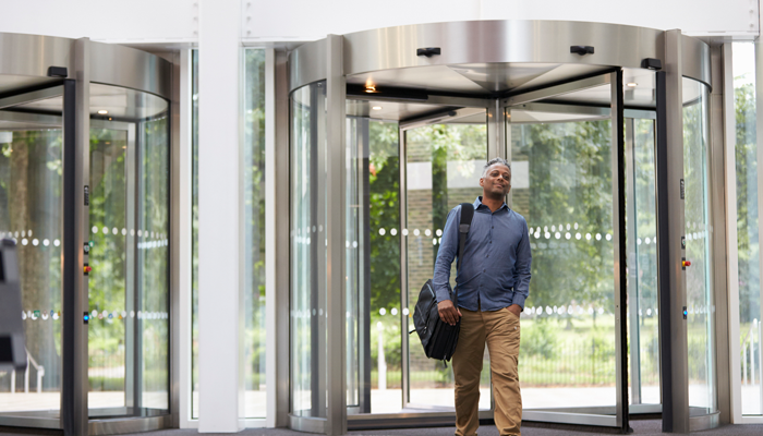 man entering a building preparing for the workplace