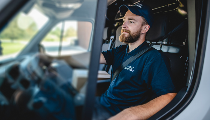 company driver sitting in driver seat indicating the jobs that require driver's abstracts