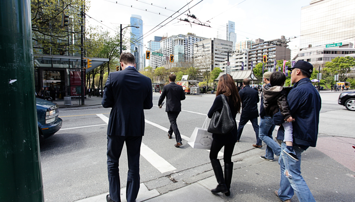 group of professionals walking at a crosswalk in toronto showcasing the job market in canada