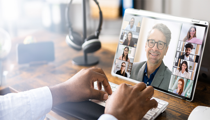 hybrid work model showcasing a laptop screen with a bunch of professionals joining a zoom call