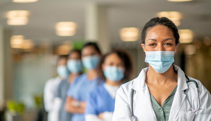 medical staff with masks on lined up in a row indicating medical staff solutions