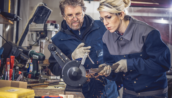 one male and one female welder working on upskilling and reskilling