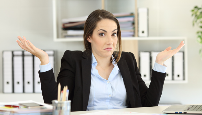 young HR professional with hands up mimicking the i don't know expression after candidate ghosting