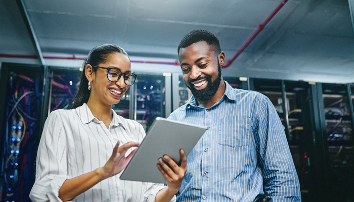 2 professionals looking at background checks for employment on a tablet