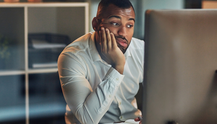 young man searching online showing when you should look for a new job