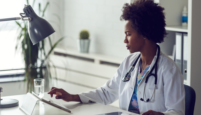 female doctor on tablet looking at Canadian blood services
